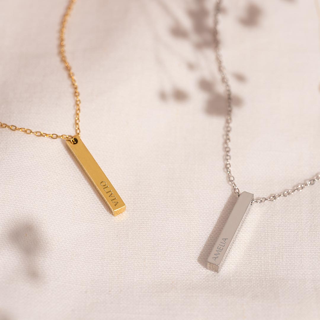 silver and gold plated asta bar charm necklaces personalised with engraved names