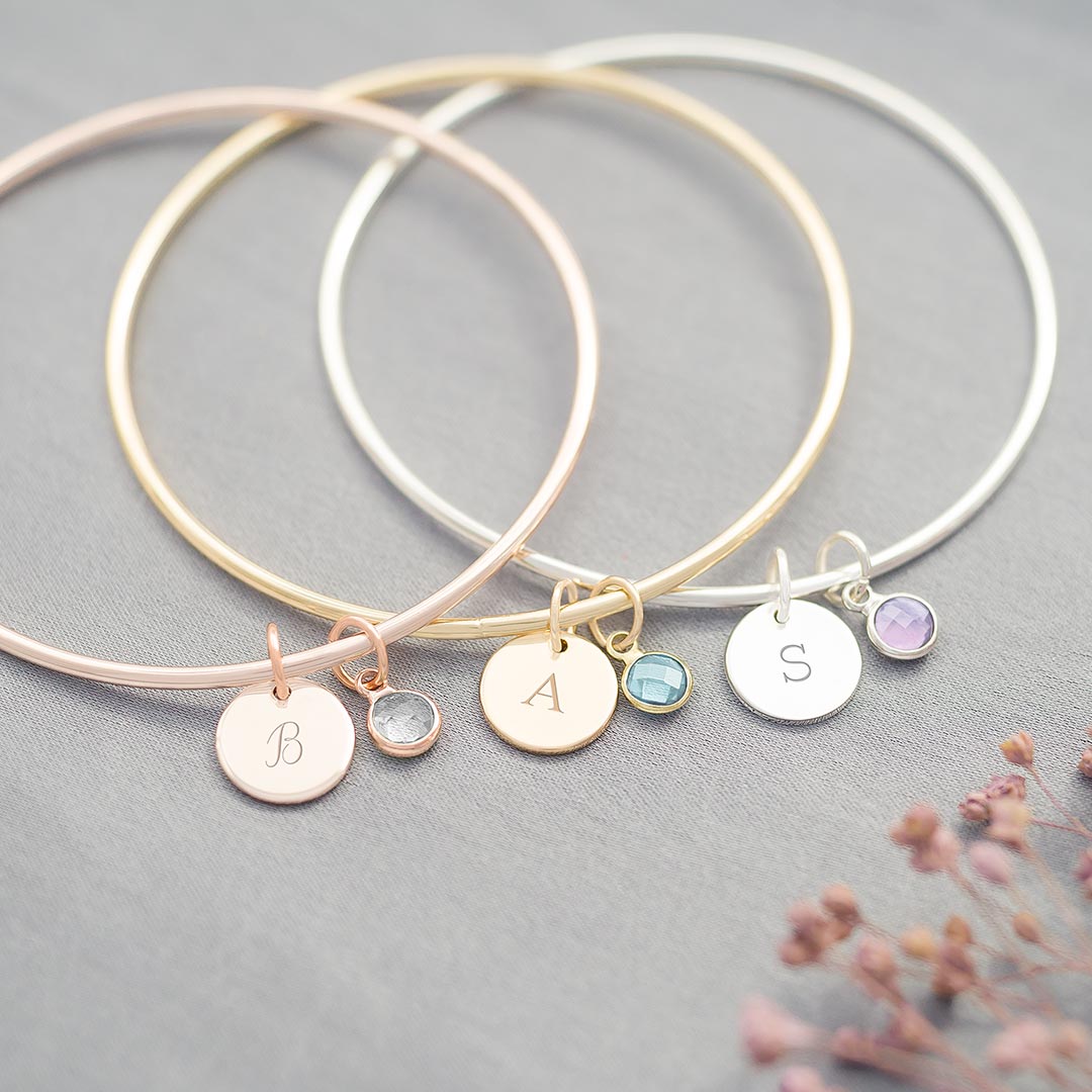 initial and birthstone bangles in silver, gold and rose gold