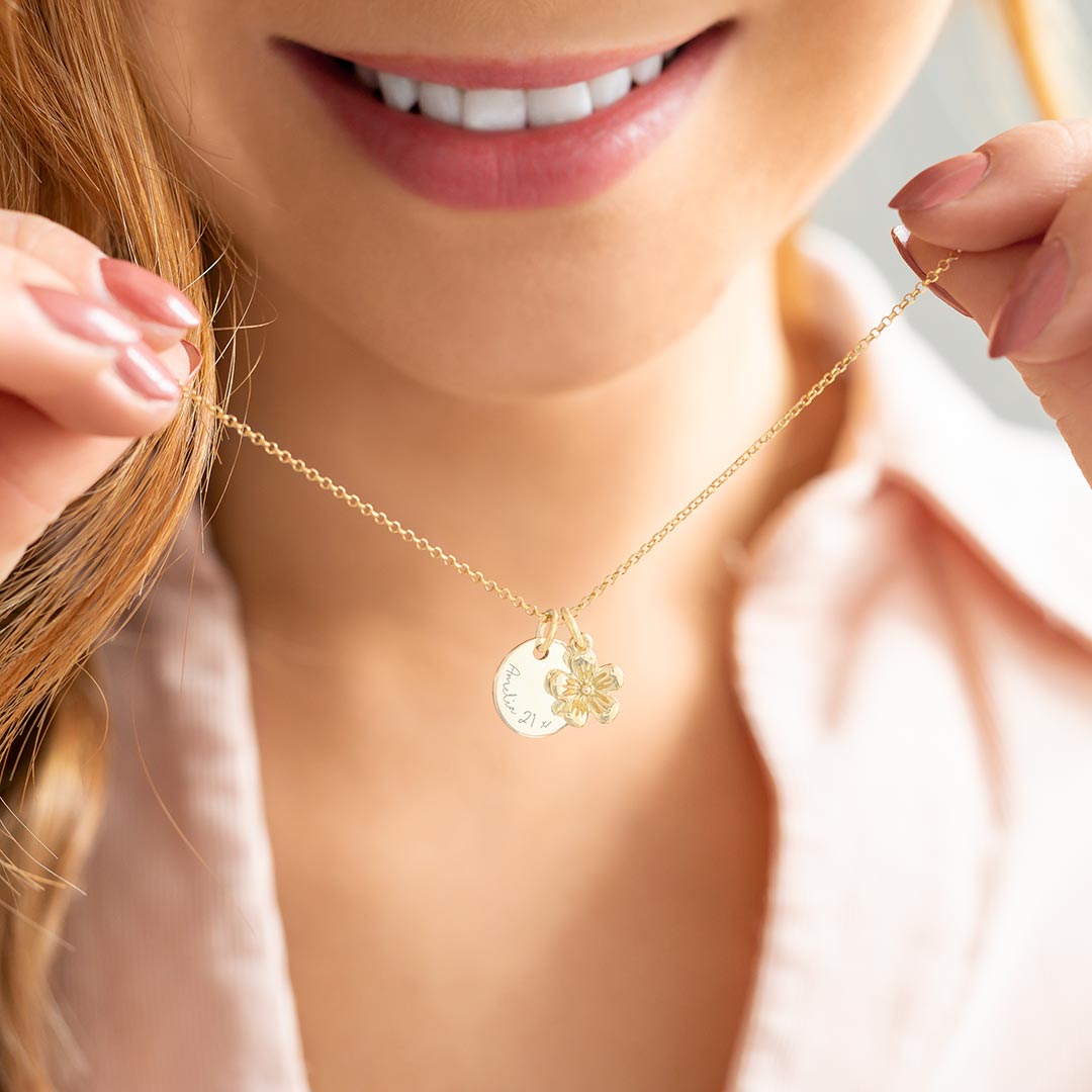 Small Champagne Gold Sterling Silver Flower alongside a 12 mm disc charm hanging on a necklace
